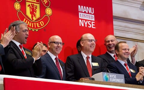 Manchester United Executives Joel Glazer (2nd L) and Avram Glazer (C) and Ed Woodward prepare to ring the Opening Bell at the New York Stock Exchange on August 10, 2012 in New York City - Credit: Getty Images