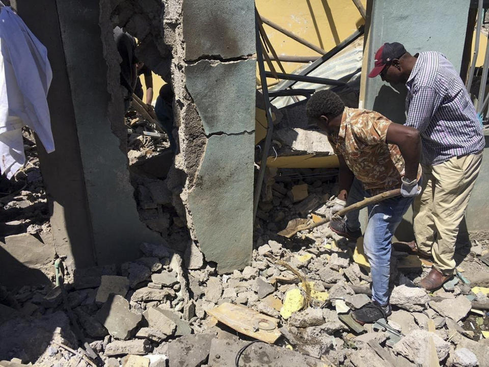 Residents dig through rubble from a destroyed building at the scene of an airstrike in Mekele, in the Tigray region of northern Ethiopia Thursday, Oct. 28, 2021. An Ethiopian government spokesman says a new airstrike has hit Mekele, targeting a site used by rival Tigray forces to make and repair weapons, while a Tigray spokesman instead says it struck a "civilian residence" killing six people and wounding more than 20. (AP Photo)