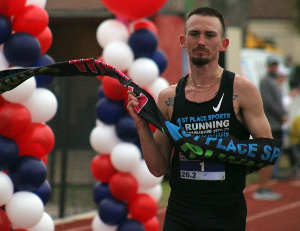 Jacksonville's Sem Sultanov, a former University of North Florida and Mandarin High School runner, breaks the tape to win the men's race at the Ameris Bank Jacksonville Marathon at The Bolles School on Sunday.