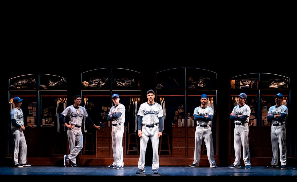 This image released by Polk & Co. shows Jesse Williams, center, during a performance of the Broadway revival of the baseball-themed “Take Me Out,” in New York. (Joan Marcus/Polk & Co., via AP)