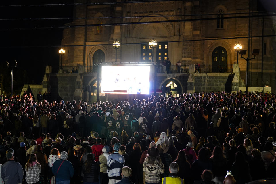 People gather at a vigil for the victims of Wednesday's mass shootings, Sunday, Oct. 29, 2023, outside the Basilica of Saints Peter and Paul in Lewiston, Maine. (AP Photo/Matt Rourke)