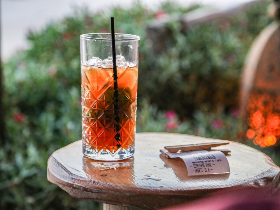 Close-Up Of Drink In Glass Jar On Table With A Bill