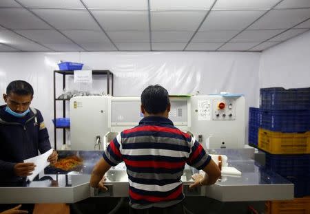 A man prepares voters' identity cards for the upcoming local election of municipalities and villages representatives at the election commission in Kathmandu, Nepal April 23, 2017. REUTERS/Navesh Chitrakar/Files