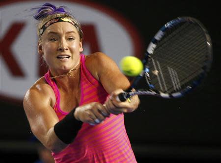 Bethanie Mattek-Sands of the United States hits a return to Maria Sharapova of Russia during their women's singles match at the Australian Open 2014 tennis tournament in Melbourne January 14, 2014. REUTERS/Petar Kujundzic