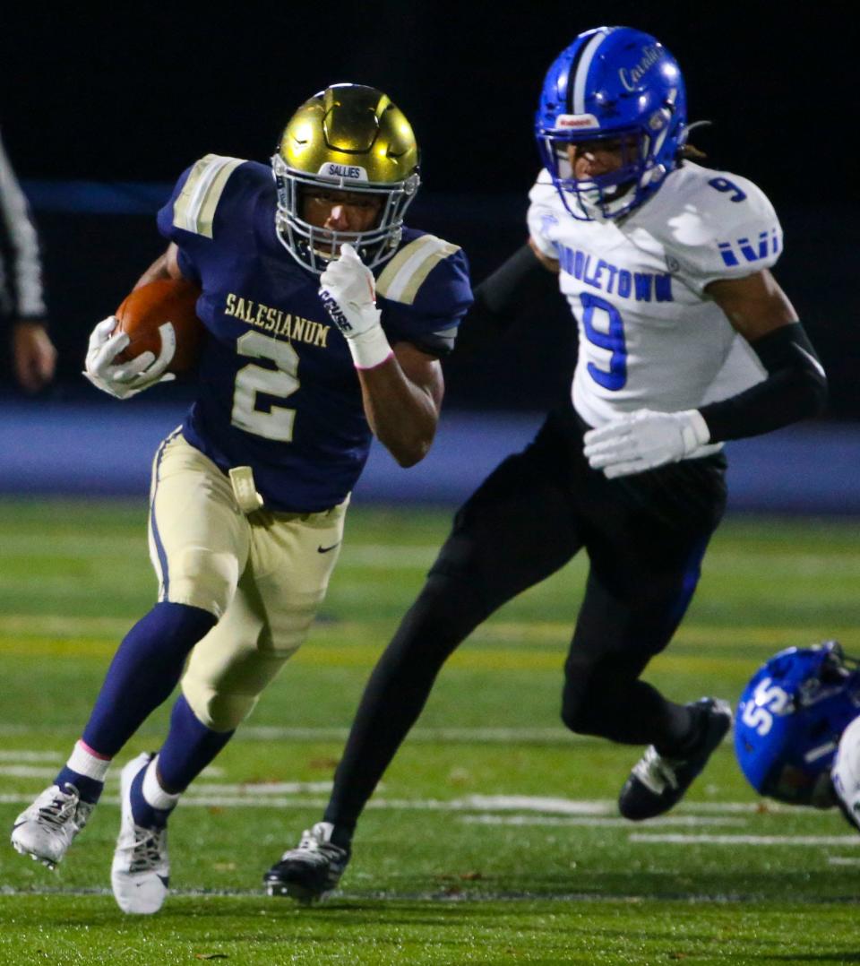 Salesianum's B.J. Alleyne takes off on a gain ahead of Middletown's Akendre Matthews in the first quarter of Salesianum's 24-14 win against Middletown in a DIAA Class 3A state tournament semifinal at Abessinio Stadium, Friday, Nov. 24, 2023.