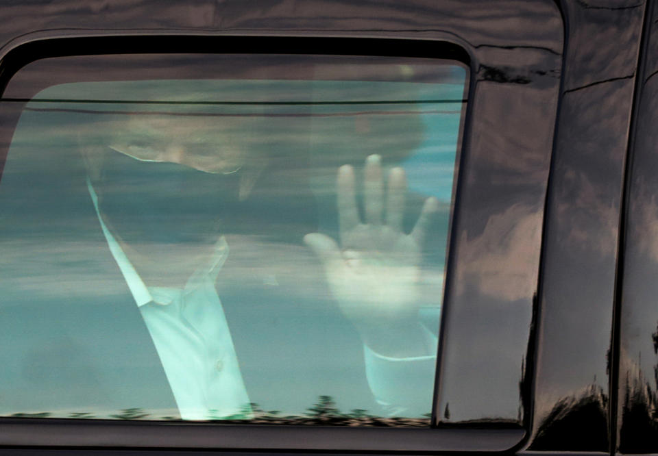 U.S. President Donald Trump waves to supporters as he briefly rides by in the presidential motorcade in front of Walter Reed National Military Medical Center, where he is being treated for coronavirus disease (COVID-19) in Bethesda, Maryland, U.S. October 4, 2020.  REUTERS/Cheriss May     TPX IMAGES OF THE DAY