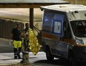 Migrants evacuated from Spanish rescue ship Open Arms disembark in Lampedusa