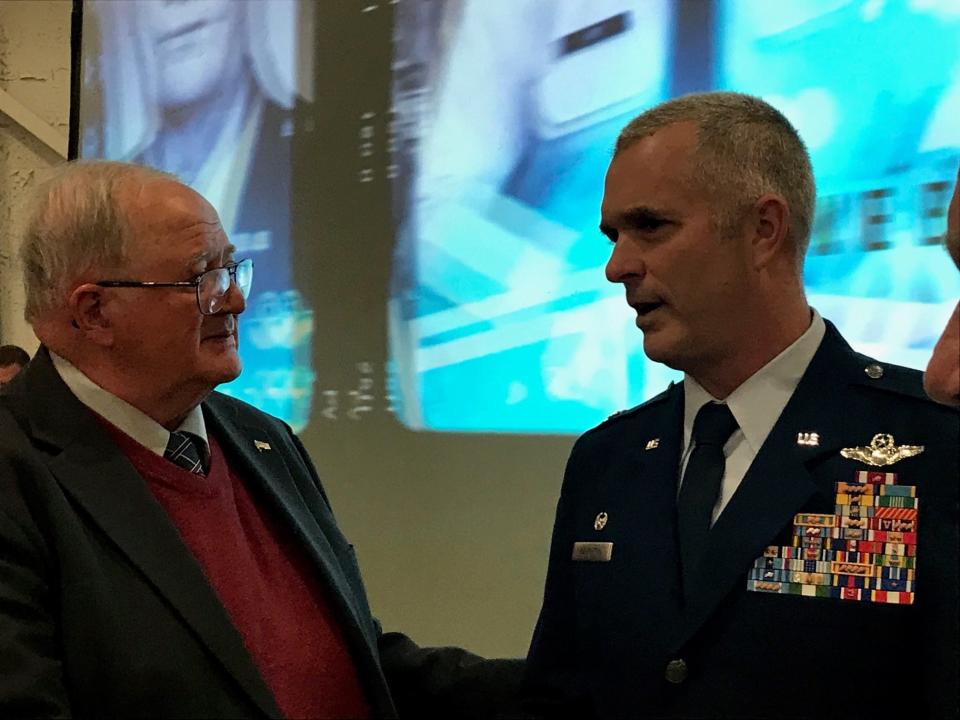 Richland County Commissioner Darrell Banks, at left, congratulates Col. Darren Hamilton after he was sworn in as the new commander of the 179th Airlift Wing of of the Ohio Air National Guard at Mansfield Lahm Airport.