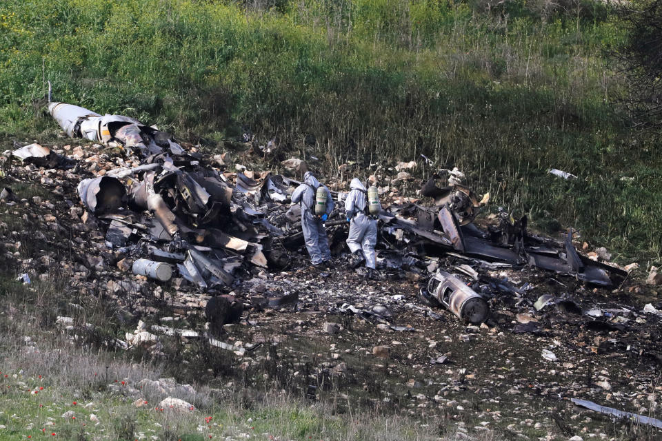 <p>Israeli security forces examine the remains of an F-16 Israeli war plane near the Israeli village of Harduf, Israel, Feb. 10, 2018. (Photo: Ronen Zvulun/Reuters) </p>