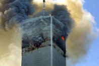 <p>Fire and smoke billows from the north tower of New York's World Trade Center on Tuesday, Sept. 11, 2001. (AP Photo/David Karp)</p> 