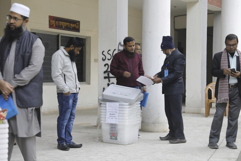 Election officers check ballot boxes for distribution in Dhaka, Bangladesh,Saturday, Jan. 6, 2024. An apparent arson fire on a train in Bangladesh’s capital killed four people late Friday and added to the country’s extreme tension ahead of Sunday’s parliamentary elections that the opposition is seeking to boycott and disrupt with a general strike. (AP Photo/Mahmud Hossain Opu)