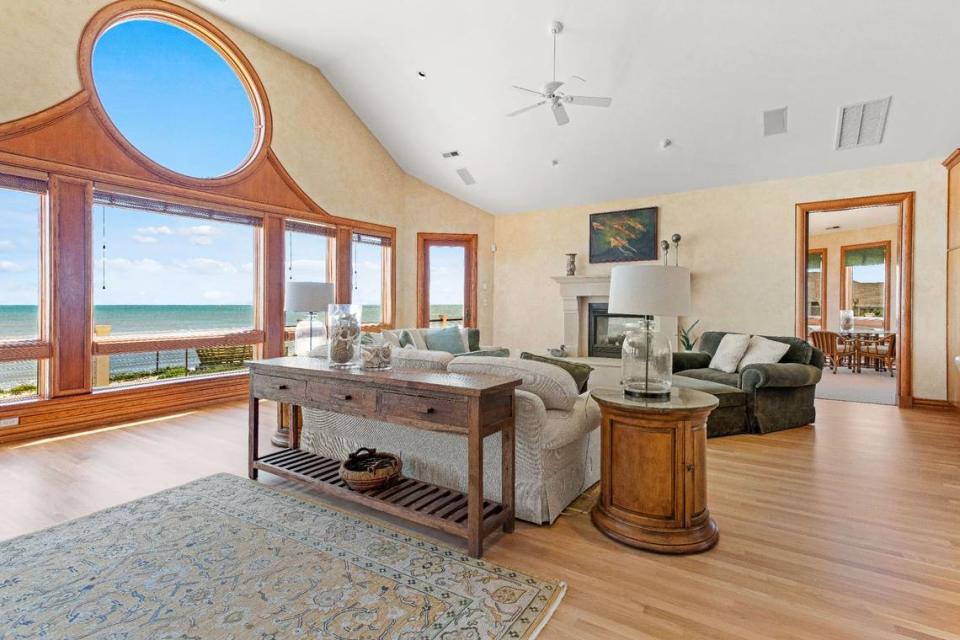 The living area is an open-concept floor plan with an expansive great room featuring huge windows overlooking the ocean.