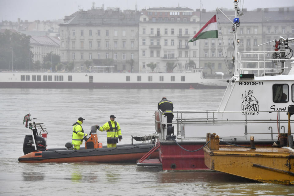 A ship tows a floating pier to Margaret Bridge during the seach operation on the River Danube in downtown Budapest, Hungary, Thursday, May 30, 2019, following a collision of a hotelship and a smaller cruise ship on the previous evening. The cruise ship sank with thirty-three South Korean passengers and two Hungarian staff on board. At least seven people died and nineteen are missing. The shipwreck was found at Margaret Bridge. (Zoltan Mathe/MTI via AP)