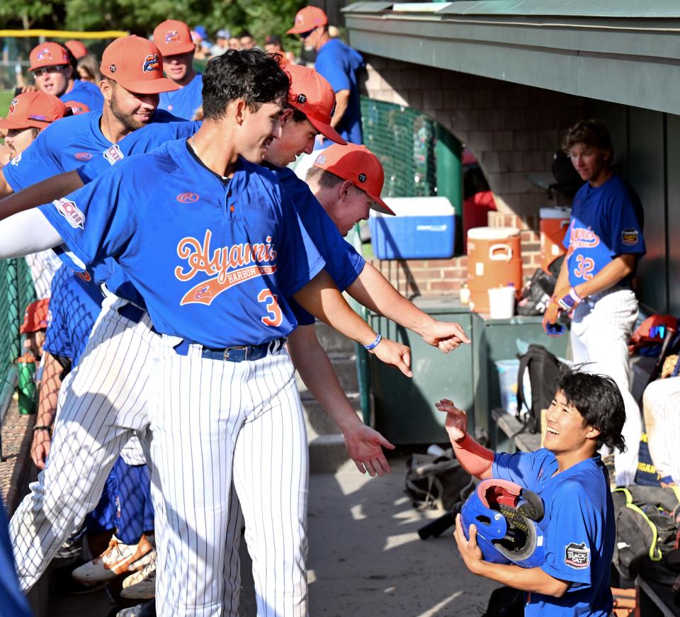 Second baseman Rikuu Nishida is welcomed to the Hyannis dugout after hitting a double against Cotuit, leading to a change in pitchers on July 27, 2022, in Cotuit.