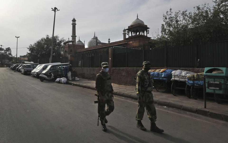 Indian para-military soldiers patrol in old quarters of the city during a lockdown to control the new virus spread, in New Delhi, India, Wednesday, March 25, 2020. The world's largest democracy went under the world's biggest lockdown Wednesday, with India's 1.3 billion people ordered to stay home in a bid to stop the coronavirus pandemic from spreading and overwhelming its fragile health care system as it has done elsewhere. The new coronavirus causes mild or moderate symptoms for most people, but for some, especially older adults and people with existing health problems, it can cause more severe illness or death. (AP Photo/Manish Swarup)