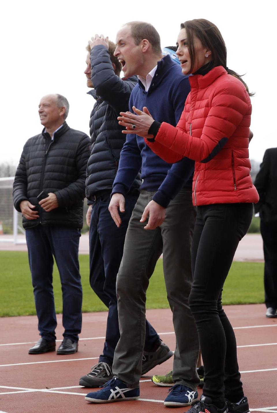 Britain's Prince William, centre, Kate Duchess of Cambridge, right, and Prince Harry react as they take part in a relay race, during a training event to promote the charity Heads Together, at the Queen Elizabeth II Park in London, Sunday, Feb. 5, 2017. (AP Photo/Alastair Grant, Pool)