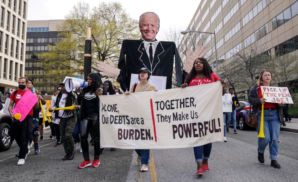 Supporters of The Debt Collective activist group walk past the U.S. Department of Education to demand full student debt cancellation on April 04, 2022, in Washington, D.C.