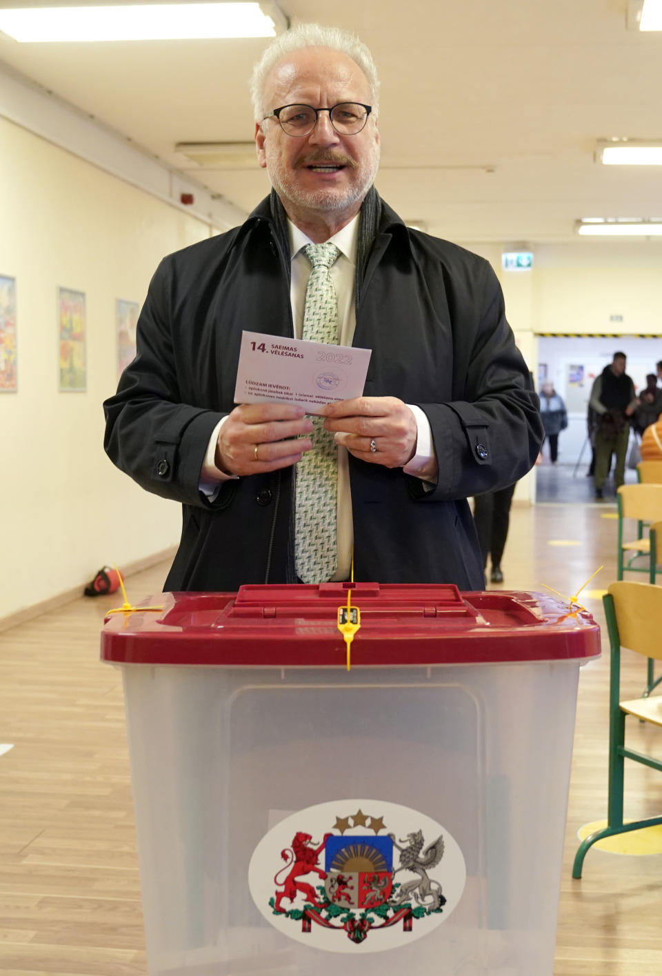 Latvian President Egils Levits casts his ballot at a polling station during general elections in Riga, Latvia, Saturday, Oct. 1, 2022. Polling stations opened Saturday in Latvia for a general election influenced by neighboring Russia’s attack on Ukraine, disintegration among the Baltic country’s sizable ethnic-Russian minority and the economy, particularly high energy prices. (AP Photo/Roman Koksarov)