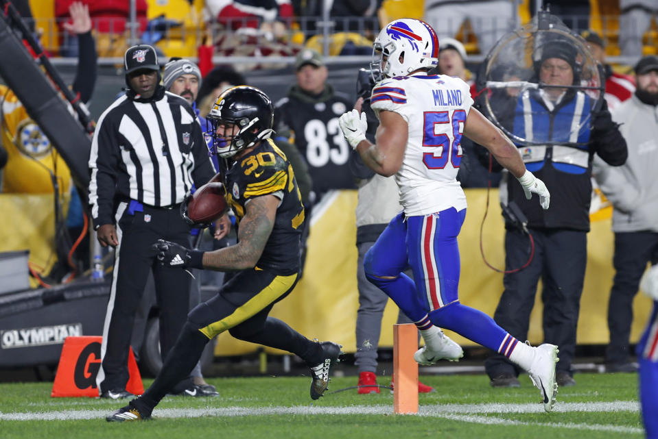 Pittsburgh Steelers running back James Conner (30) scores with Buffalo Bills outside linebacker Matt Milano (58) defending during the second half of an NFL football game in Pittsburgh, Sunday, Dec. 15, 2019. (AP Photo/Keith Srakocic)