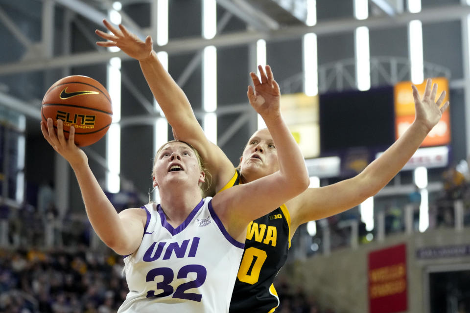Northern Iowa center Rachael Heittola (32) is fouled by Iowa center Sharon Goodman, rear, during the first half of an NCAA college basketball game, Sunday, Nov. 12, 2023, in Cedar Falls, Iowa. (AP Photo/Charlie Neibergall)