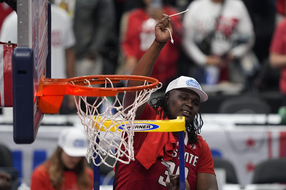 North Carolina State forward DJ Burns Jr. (30) after cutting the net after winning an NCAA college basketball game against North Carolina to win the championship of the Atlantic Coast Conference tournament, Saturday, March 16, 2024, in Washington. North Carolina State won 84-76. (AP Photo/Susan Walsh)