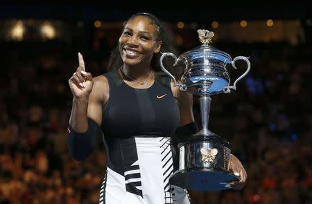 Tennis - Australian Open - Melbourne Park, Melbourne, Australia - 28/1/17 Serena Williams of the U.S. gestures while holding her trophy after winning her Women's singles final match against Venus Williams of the U.S. .REUTERS/Issei Kato