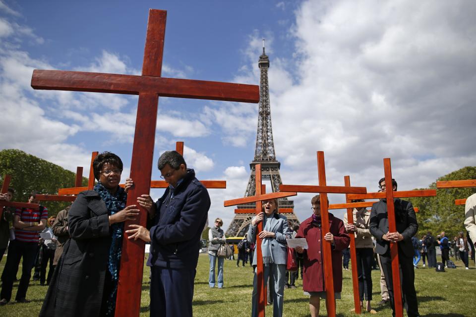 Pilgrims attend the annual Good Friday "Stations of the Cross" procession at the Champs de Mars near the Eiffel Tower in Paris