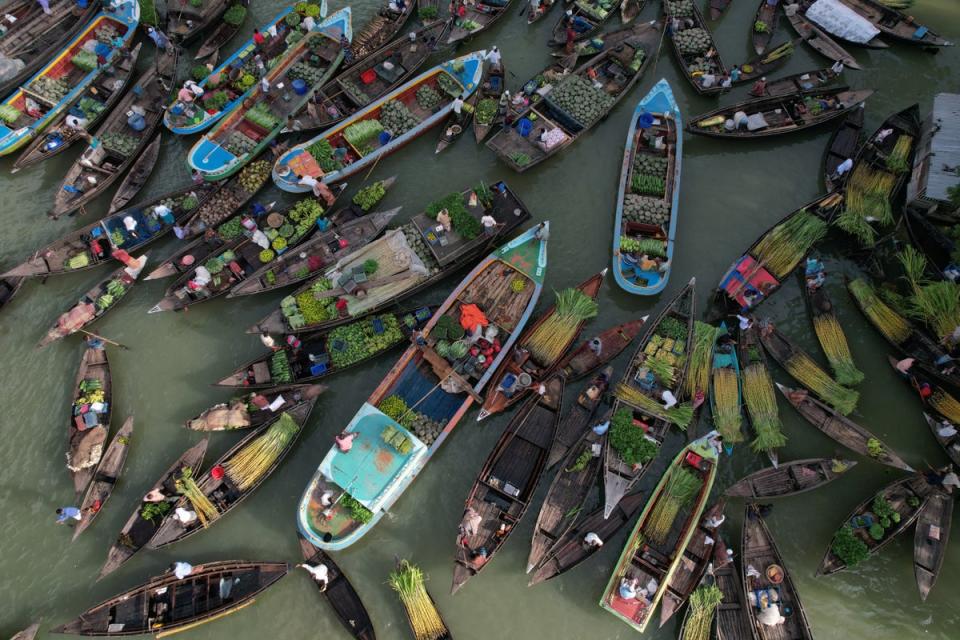 Farmers selling at a floating market (Reuters)