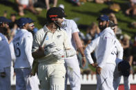 New Zealand's Kane Williamson looks back as the Indian team celebrates after India's Mohammed Shami had dismissed him for 89 during the first cricket test between India and New Zealand at the Basin Reserve in Wellington, New Zealand, Saturday, Feb. 22, 2020. (AP Photo/Ross Setford)