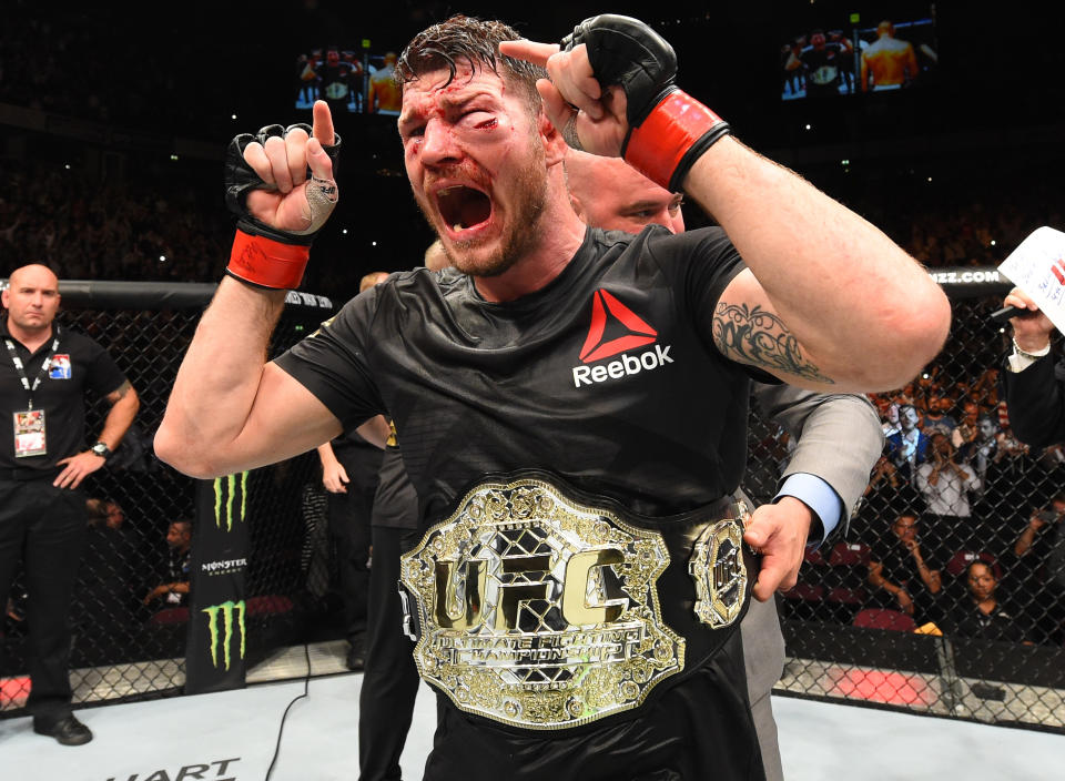 Michael Bisping celebrates his victory over Dan Henderson in their UFC middleweight championship bout on Oct. 8, 2016 in Manchester, England. (Getty Images)