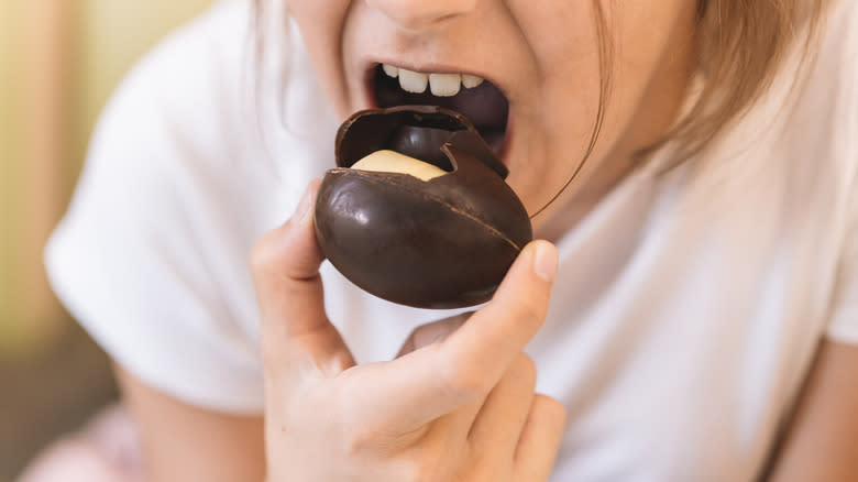 child biting into Kinder egg