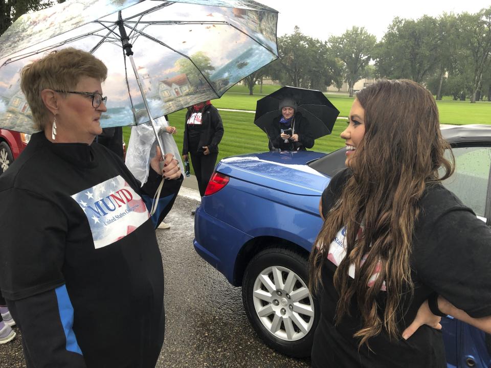 Former Miss America Cara Mund, right, speaks with a supporter in Bismarck, N.D., Saturday, Sept. 17, 2022. Mund is running as an independent candidate for North Dakota’s lone U.S. House seat. (AP Photo/James MacPherson)