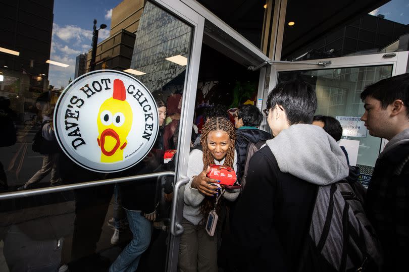 Dave's Hot Chicken shop front with people queuing