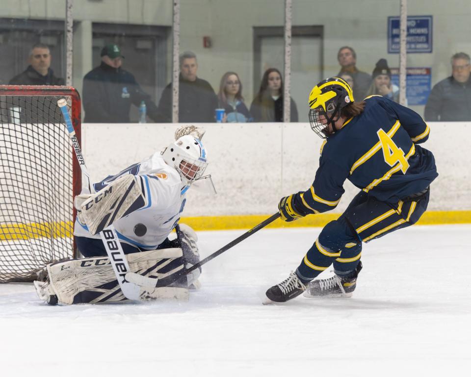 Livonia Stevenson's Zach Waldo turns aside a shot by by Hartland's Brady Balagna during the Spartans' 3-1 loss on Wednesday, Jan. 26, 2022 at Eddie Edgar Ice Arena.