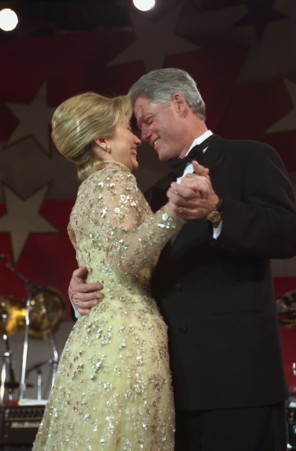 <p>While celebrating his second inauguration, the Clintons shared a dance at the inaugural ball. Hillary Clinton opted for a long-sleeve lace gold gown designed by Oscar de la Renta. </p>