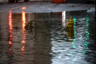 <p>Lights are reflected beside a submerged water hydrant in floodwaters after Hurricane Irma in Jacksonville, Fla. on Sept. 11, 2017. (Photo: Mark Makela/Reuters) </p>