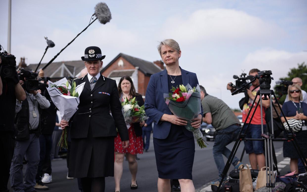 Home Secretary Yvette Cooper lays flowers at the scene where two children were stabbed to death