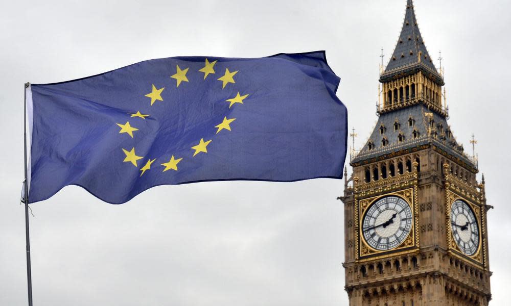 an EU flag flying in front of the Houses of Parliament in Westminster, London