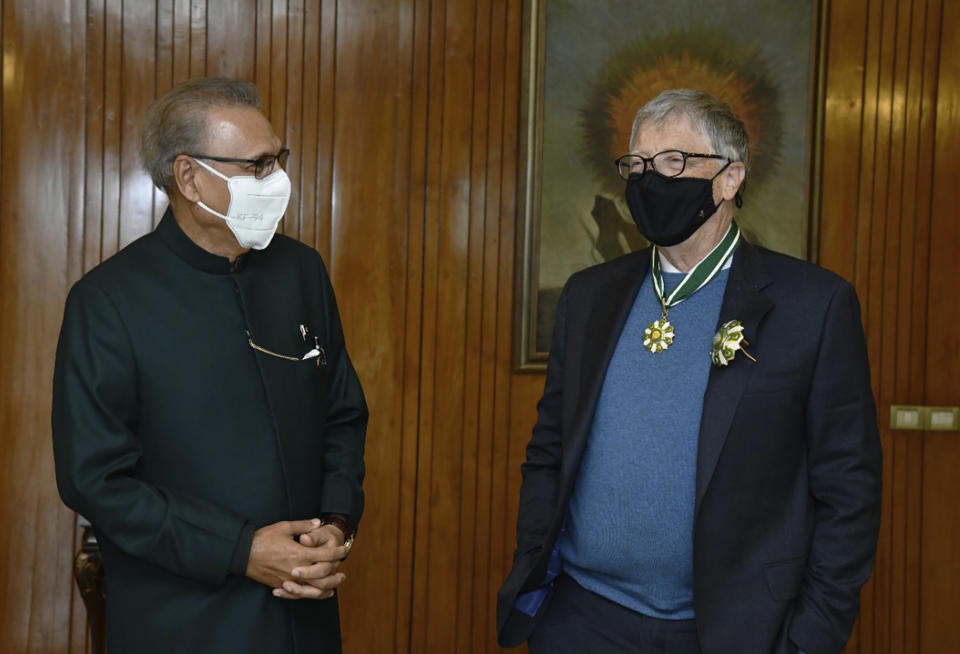 In this photo released by Pakistan's Press Information Department, Pakistan's President Arif Alvi, left, listens to the Microsoft co-founder and billionaire philanthropist Bill Gates at a ceremony where he was awarded the country's second highest civilian award, Hilal-e-Pakistan, in Islamabad, Pakistan, Thursday, Feb. 17, 2022. Pakistan awarded Gates in recognition of his work to alleviate poverty and diseases like polio and tuberculosis. (Press Information Department via AP)