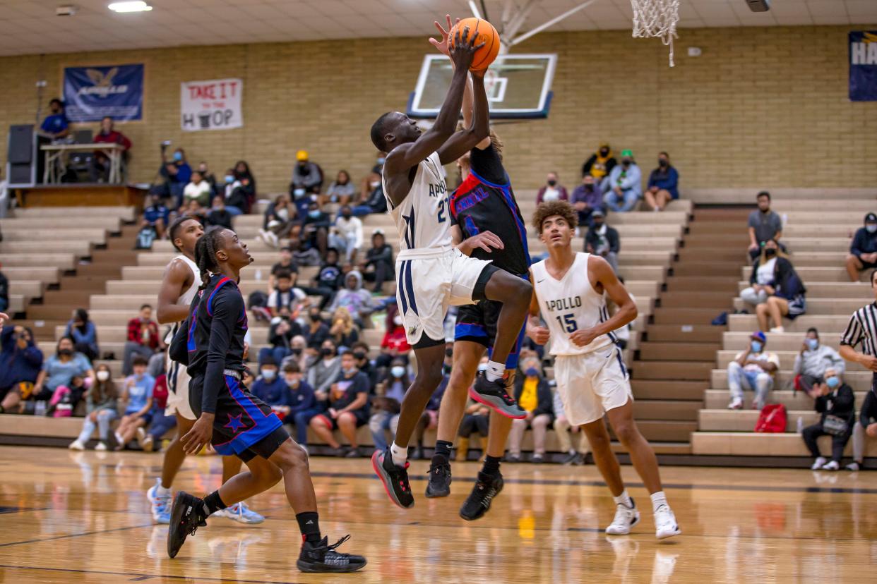 Ahamed Mohamed of Apollo High School jumps to shoot the ball as Centennial High School's Jacob Lifgren attempts to block him during a basketball game against Centennial High School at Apollo High School in Glendale on Jan. 10, 2022.