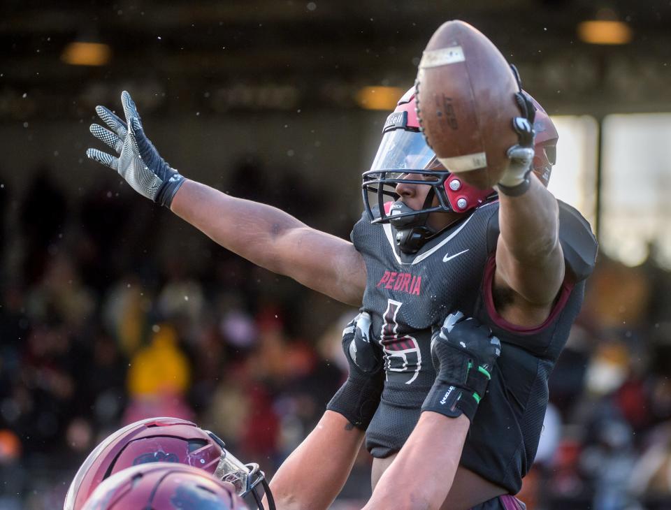 Peoria running back Malachi Washington celebrates a touchdown against Morris in the first half of their Class 5A football state semifinal Saturday, Nov. 19, 2022 at Peoria Stadium.