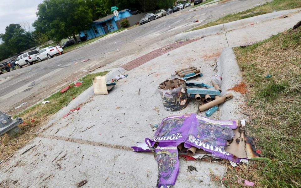 Trash from fireworks left on the sidewalk near the place that a fatal shooting occurred on Castleman Street in Fort Worth.