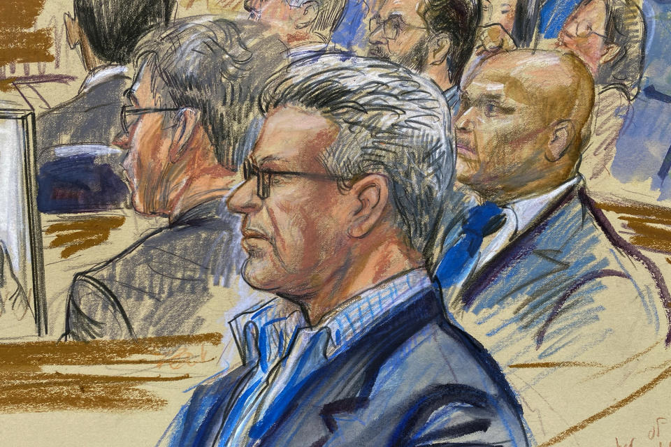 This artist sketch depicts Salah Al-Ejaili, foreground with glasses, a former Al-Jazeera journalist, before the U.S. District Court in Alexandria, Va., Tuesday, April 16, 2024. Al-Ejaili, a former detainee at the infamous Abu Ghraib prison, has described to jurors the type of abuse that is reminiscent of the scandal that erupted there 20 years ago: beatings, being stripped naked and threatened with dogs, stress positions meant to induce exhaustion and pain. (Dana Verkouteren via AP)