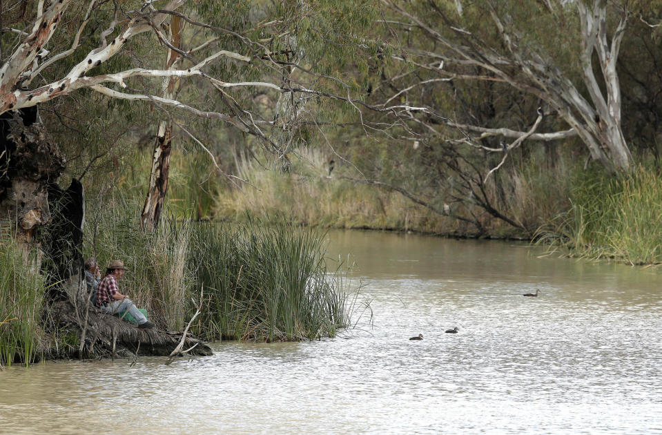 In this May 26, 2013 photo, two locals fish in the Murray river in Wentworth, 1,043 kilometers (648 miles) from Sydney, Australia, during a seven-day, 3,000-kilometer (1,900-mile) journey across the Outback. The Murray and Darling rivers offers beautiful scenery of Australia's famous bush. (AP Photo/Rob Griffith)