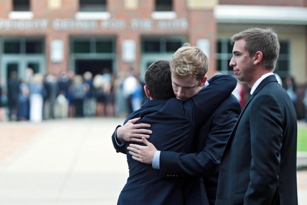 Mourners hug as they attend the funeral of Otto Warmbier: EPA
