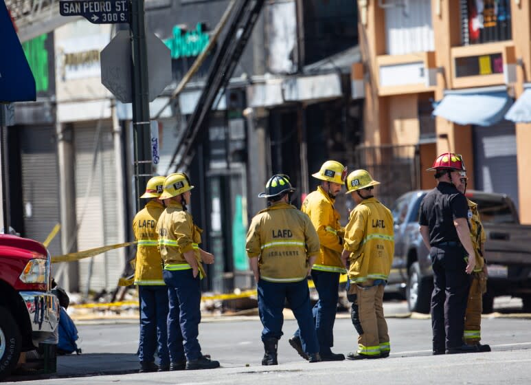 LOS ANGELES, CA - MAY 17: Firefighters and other officials investigate a downtown scene were an explosion and fire injured 11 fire fighters yesterday in Little Tokyo during the coronavirus pandemic on Sunday, May 17, 2020 in Los Angeles, CA. (Jason Armond / Los Angeles Times)