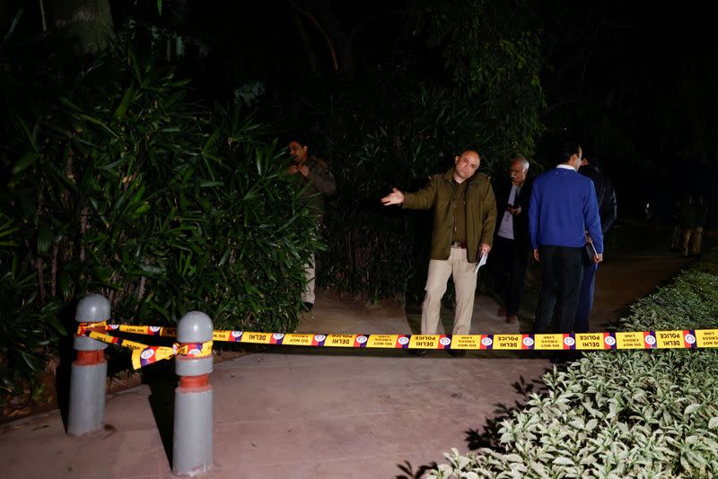 Police officials stand outside the Israeli embassy, following a reported explosion nearby, in New Delhi