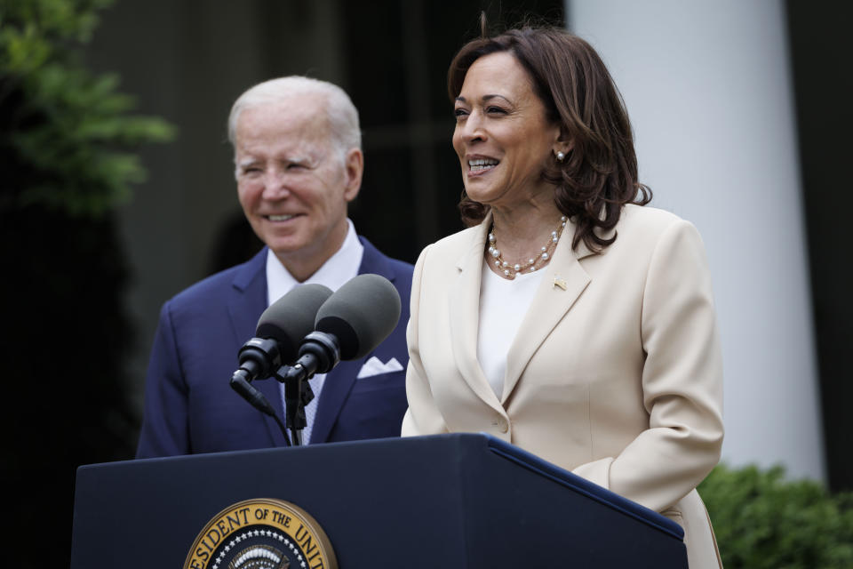 Vice President Kamala Harris, with President Biden beside her, speaks during an event in the White House Rose Garden.