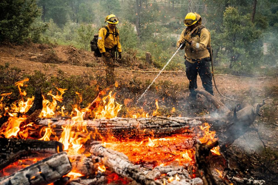 Firefighters mop up hot spots while battling the Oak Fire in the Jerseydale community of Mariposa County, Calif., on July 25.