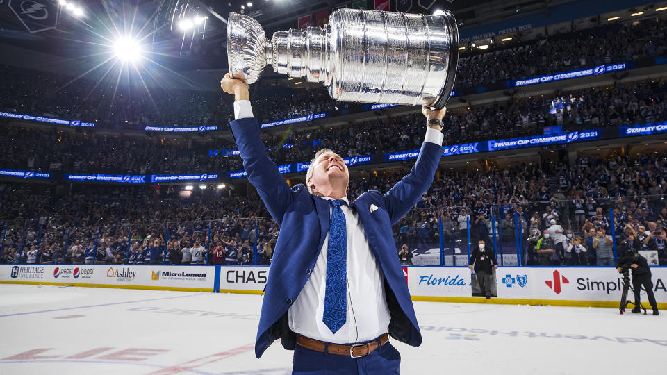 TAMPA, FL - JULY 7: Head Coach Jon Cooper of the Tampa Bay Lightning hoists the Stanley Cup overhead after the Tampa Bay Lightning defeated the Montreal Canadiens in Game Five to win the best of seven game series 4-1 during the Stanley Cup Final of the 2021 Stanley Cup Playoffs at Amalie Arena on July 7, 2021 in Tampa, Florida. (Photo by Scott Audette/NHLI via Getty Images)